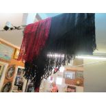 A black embroidered silk shawl with tassel edge and another red one