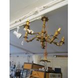 A pair of brass foliate five branch ceiling lights