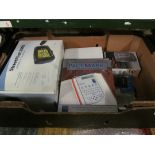 A box of items including sat-nav, radios, calculators etc