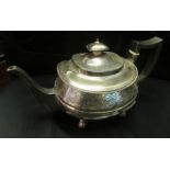 A silver teapot.