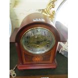 A modern arch top mantel clock with inlaid star decoration