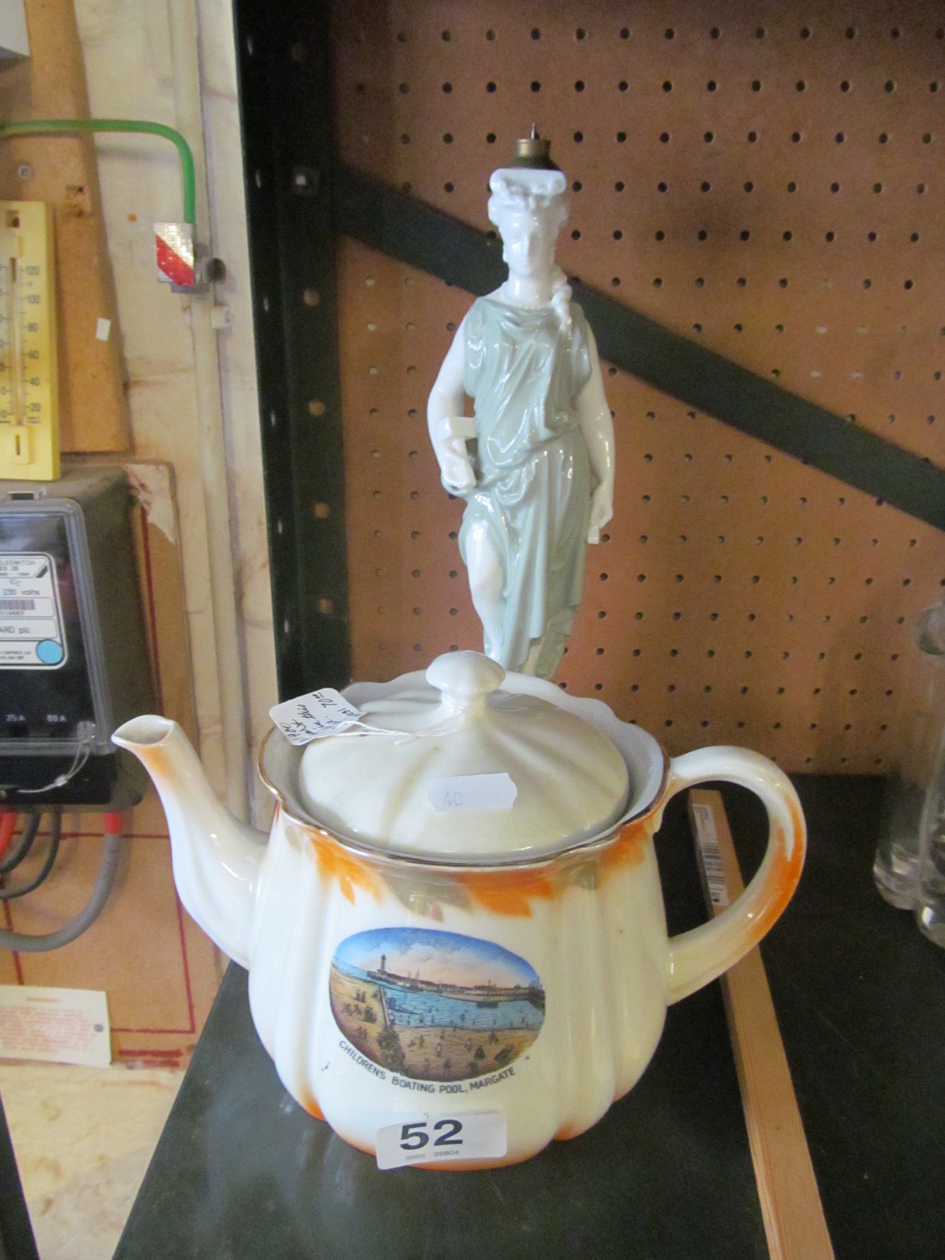 A porcelain figure grecian lady (was a lamp) and a crested ware teapot 'Childrens Boating Pool,