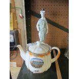 A porcelain figure grecian lady (was a lamp) and a crested ware teapot 'Childrens Boating Pool,