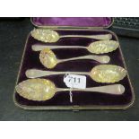 Four silver berry spoons and sifter.