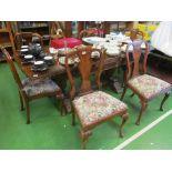 A set of six Queen Anne style walnut dining chairs with scroll tops, vase back splats and cabriole