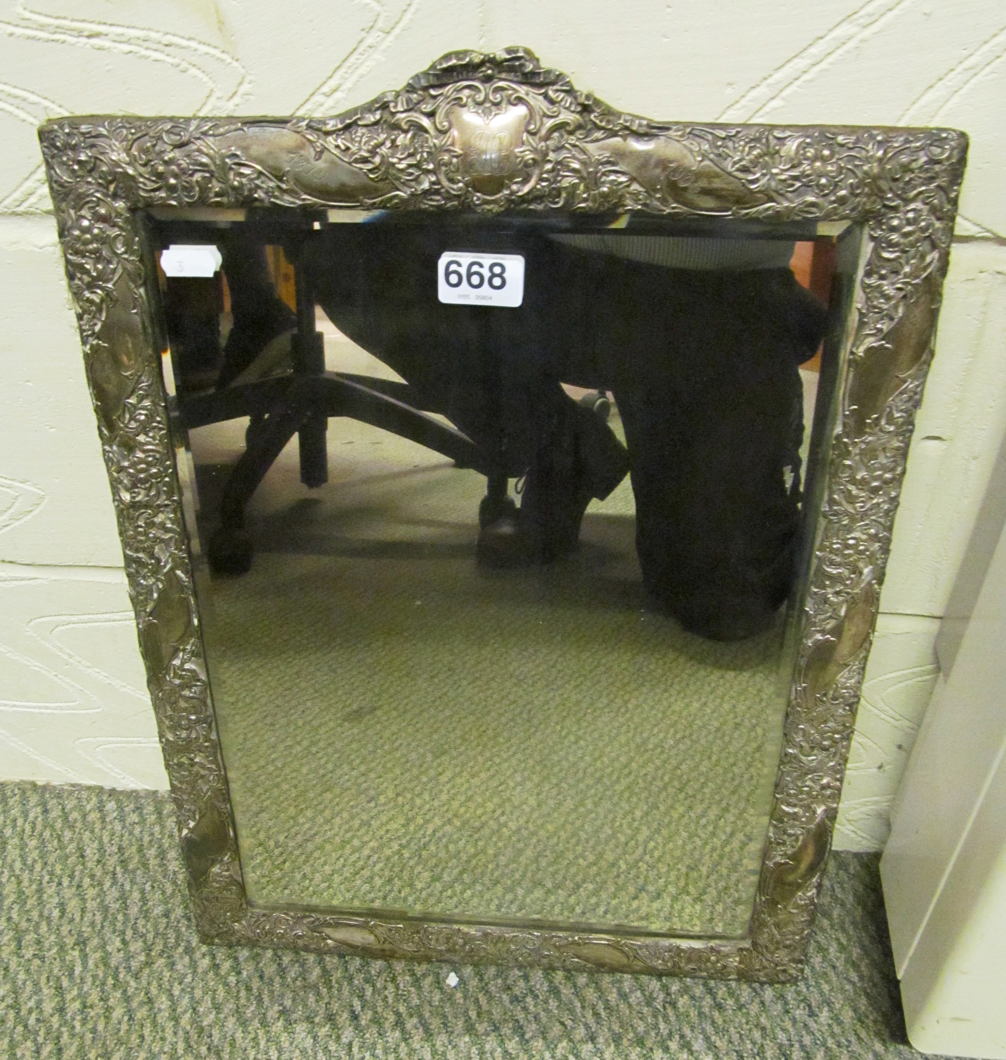 A large silver framed dressing table mirror embossed flowers with initials to top and dates 1879 and