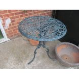 A small two seater garden bench and circular table