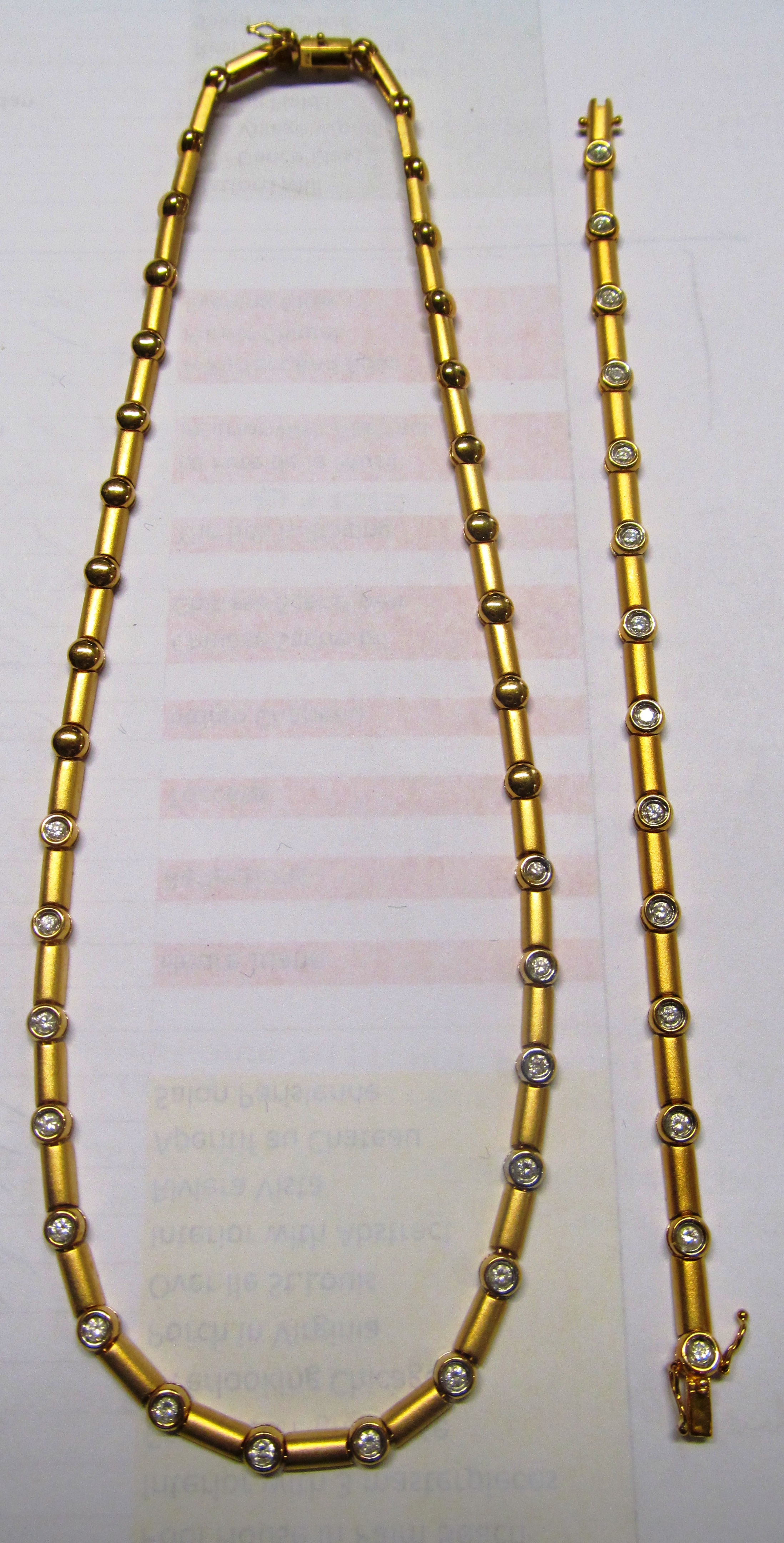 A 18ct gold articulated diamond necklace with matching bracelet which is designed to extend the