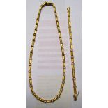 A 18ct gold articulated diamond necklace with matching bracelet which is designed to extend the
