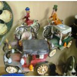 A pair of china figures man and woman on bicycle and three china vintage car ornaments