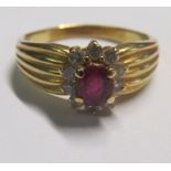 An 18ct gold ruby and diamond cluster ring