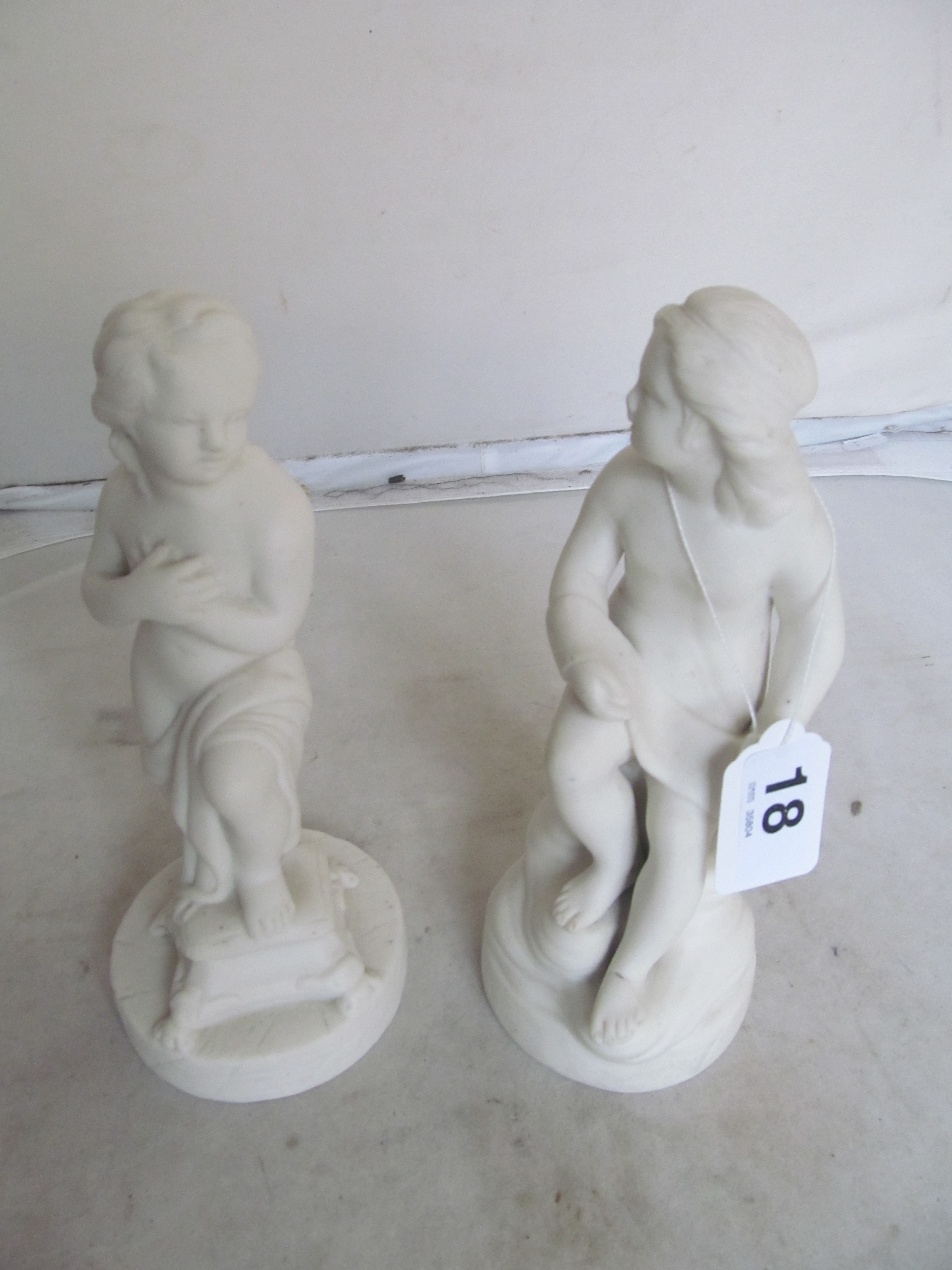 A pair of bisque figures