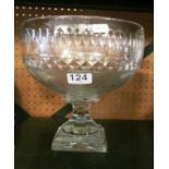 A large cut glass bowl on square stepped base