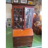A mahogany bureau bookcase with two astragal glazed doors over fall front and three drawers