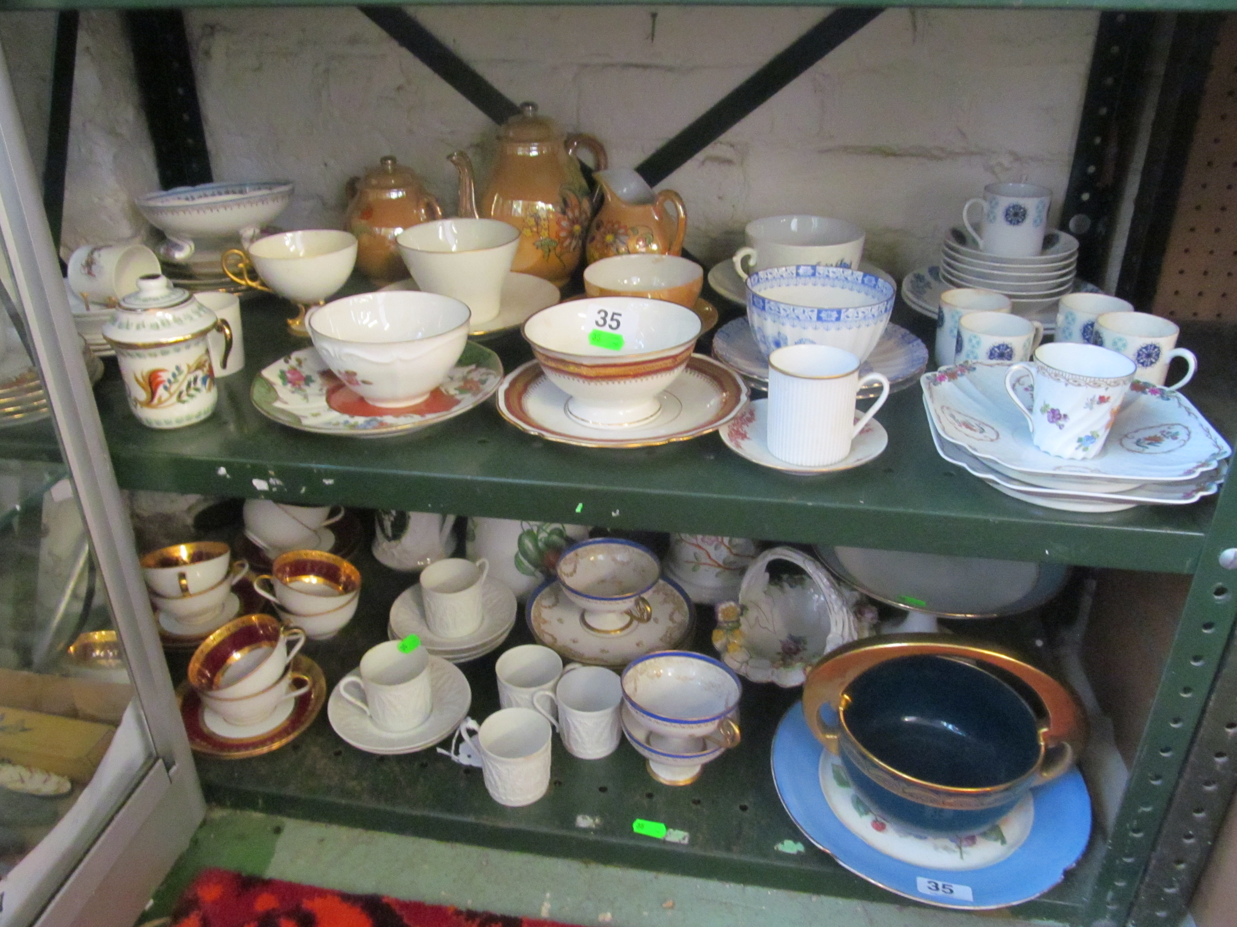 A Limoges part teaset with wide rouge and gilt border, three Limoges cups and four saucers Double