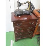 A small chest of four drawers