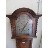 A 1920's oak Grandmother clock with silvered dial and Westminster chimes