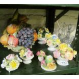 A large china basket of fruit and flower encrusted ornaments