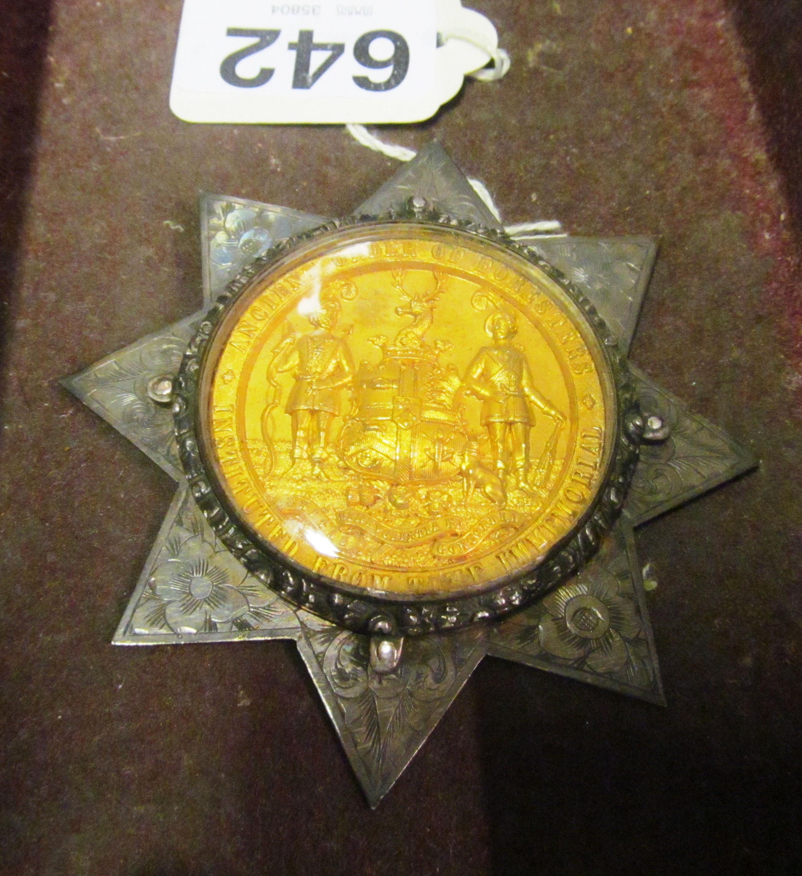 A gilt medal from The Ancient Order of Foresters mounted in Victorian silver eight pointed star