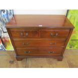 An Edwardian walnut chest of two short and two long drawers