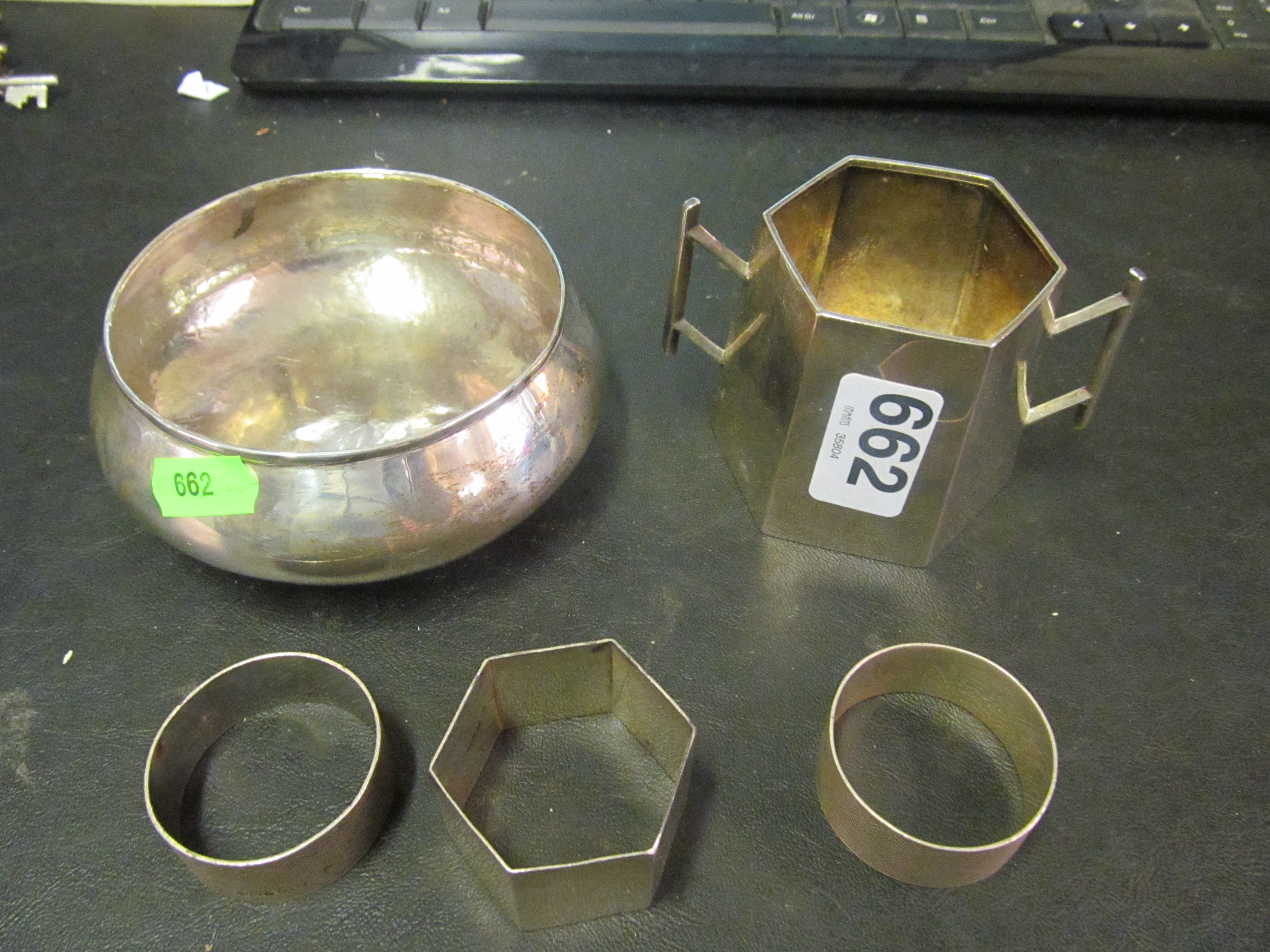 A silver bowl, sugar bowl, a pair napkin rings and another