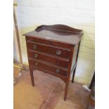 A three drawer mahogany music stand