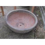 A large low circular garden pot