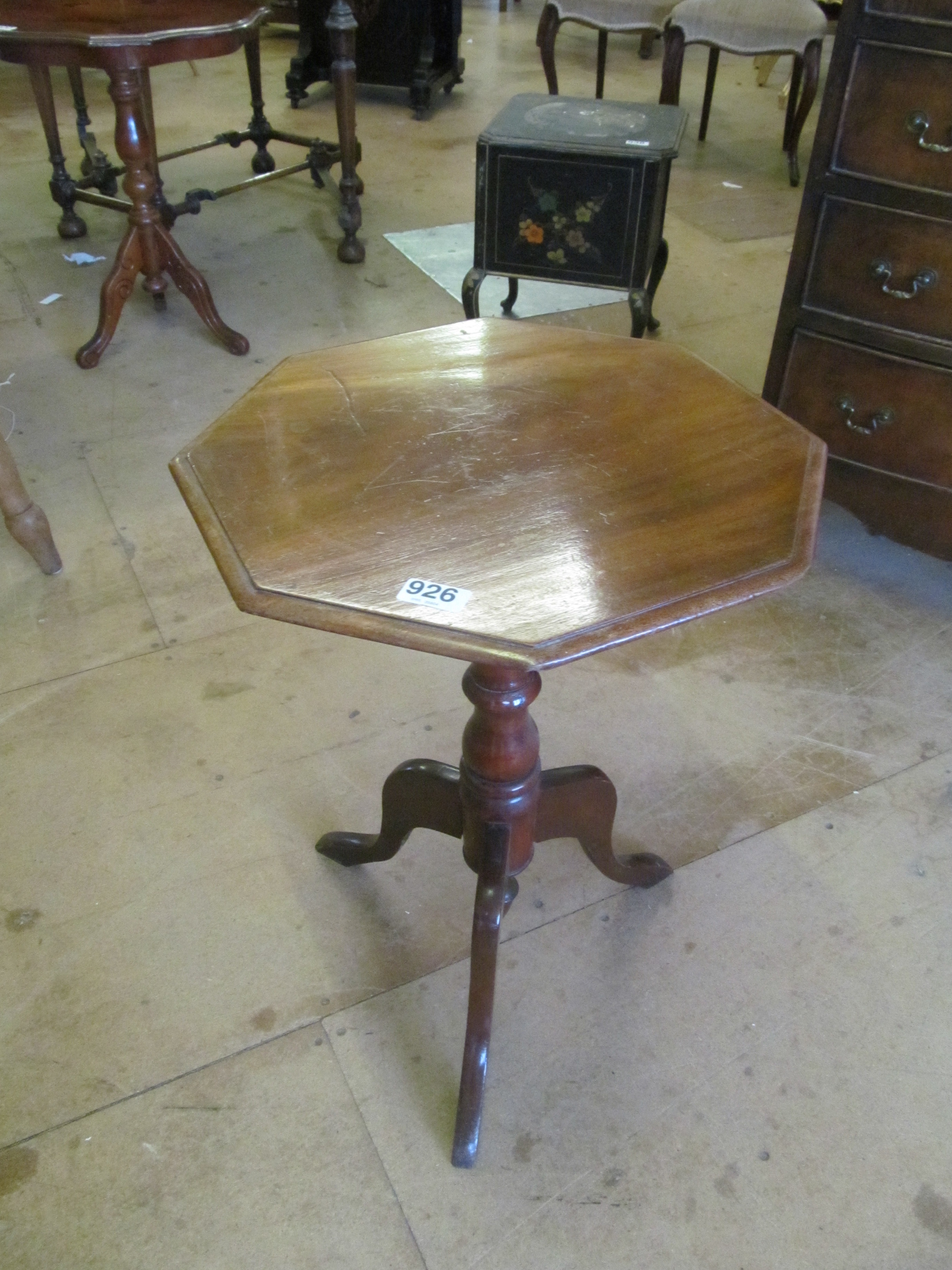 An octagonal topped occasional table on tripod supports