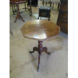 An octagonal topped occasional table on tripod supports