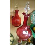 Two cranberry glass decanters