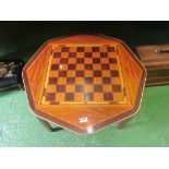 An octagonal table inlaid with chess board design