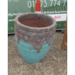 A turquoise garden urn