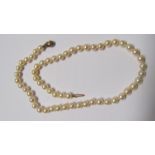 A strand of cultured pearls fitted with leaf design 9ct gold clasp