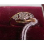 An 18ct and platinum three stone illusion set diamond ring