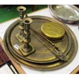 A pair brass candlesticks, two brass trays and two fire irons