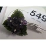 An 18ct white gold brooch set with carved amethyst flowers with diamond centres and carved jade