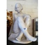 A white sculpture of girl signed