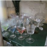 A cut glass decanter, glasses and other glass.