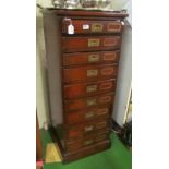 A narrow mahogany nine drawer chest military style handles