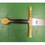 A reproduction 3.5" medieval broad sword with brass hilt and leather hand grip.