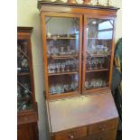 An Edwardian inlaid walnut bureau bookcase with moulded cornice, two astragal glazed doors, fall