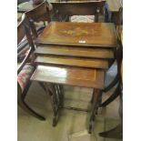 A nest of four early 20th Century occasional tables inlaid geometric pattern and flowers on turned