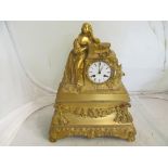 A 19th Century gilt ormolu clock with lady resting on pediment, wreath to front.