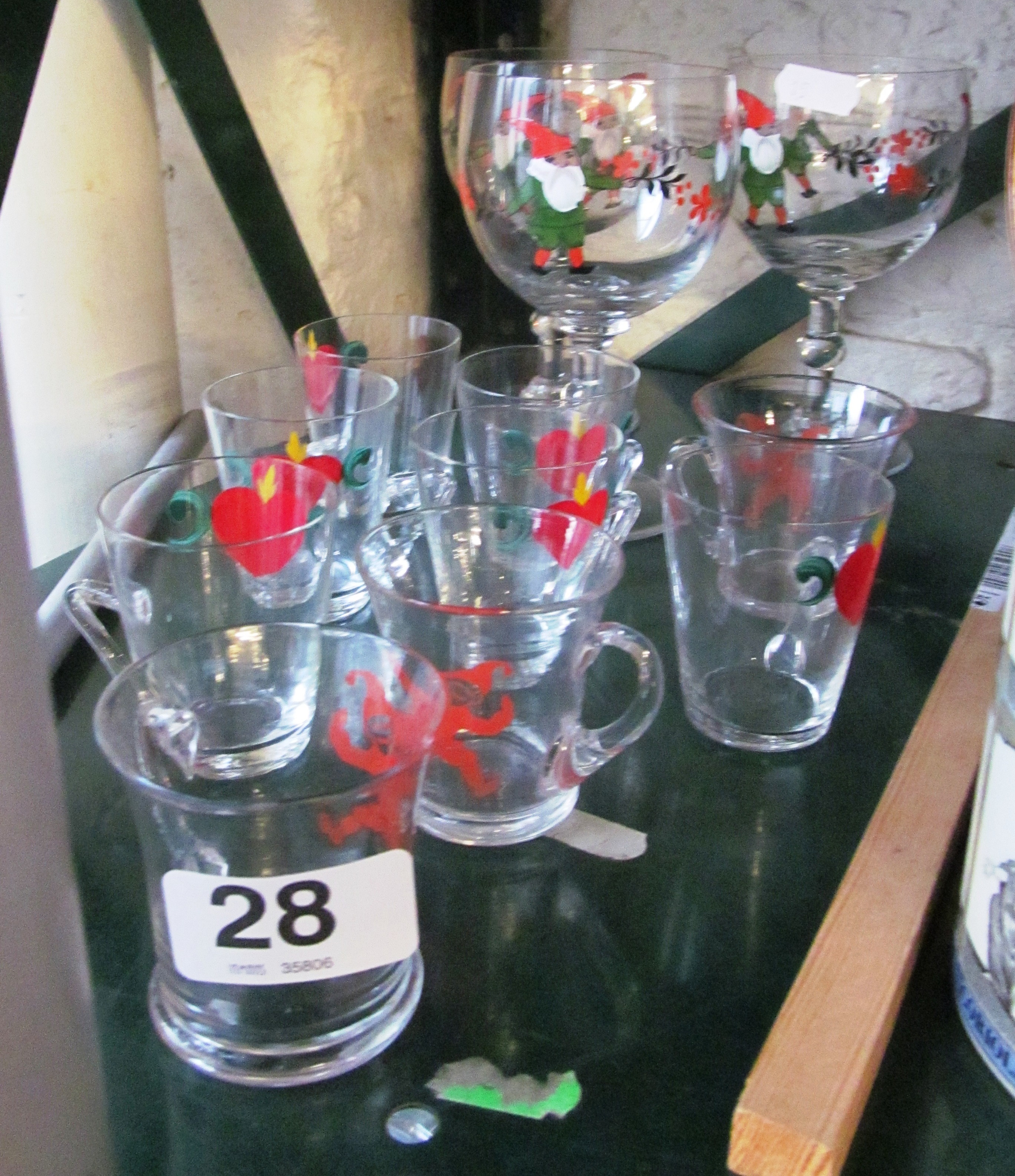 Three Christmas decoration wine glasses and some smaller Christmas decoration glasses