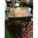 An Edwardian rosewood square drop flap table with galleried shelf.