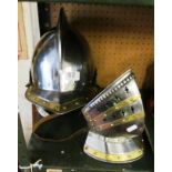 A reproduction steel and brass armoured helmet with face guard and inner head cloth.