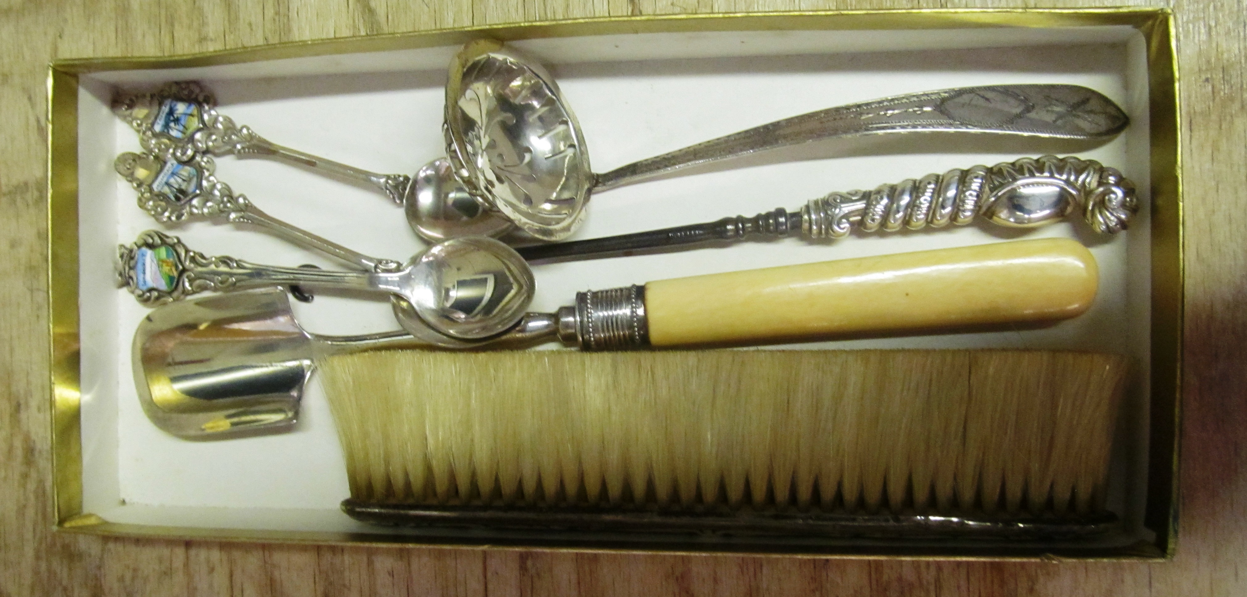 A silver scoop, brush, ladle, button hook and three 800 standard spoons