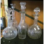 Six tall glass decanters.