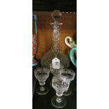 A vine fruit decanter and four glasses