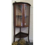 An Edwardian mahogany corner display cabinet with two glazed doors